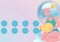 Composition of aquarius figure with eight blue circles on pale pink background