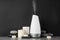 Composition with aroma humidifier on table against black background. Space for