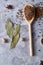 Composition with aromatic peppercorn in the wooden spoons on the white background, flat lay, close-up, selective focus.