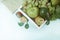 Composition with assorted raw organic green vegetables and friuts on the white wooden tray. Top view. Copy space