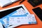Composition with avia tickets and tablet on orange background. Travel agency concept