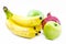 Composition of bananas, green apples and a pomegranate on a white background