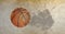 Composition of basketball in air over cracked distressed surface