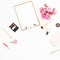 Composition for beauty blog with pink roses bouquet, cosmetics, diary and clipboard on white background. Top view. Flat lay, copy