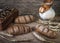 Composition black bread on the board, vintage knife, milk, wheat flakes, nuts on the table and the old background, concept of heal