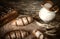 Composition black bread on the board, vintage knife, milk, wheat flakes, nuts on the table and the old background, concept of heal