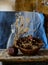 Composition of a bottle, pomegranate, basket and withered flowers