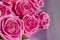 Composition with a bouquet of pink roses on a delicate fabric background. A holiday gift, pastel colors. Festive delicate