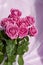 Composition with a bouquet of pink roses on a delicate fabric background. A holiday gift, pastel colors. Festive delicate