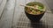 Composition of bowl of pad thai with chopsticks on wooden background