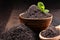 Composition with bowl of poppy seeds on wooden table