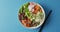 Composition of bowl of rice, salmon and vegetables with chopsticks on blue background