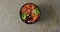 Composition of bowl of rice, salmon and vegetables with chopsticks on white background