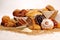 Composition with bread and rolls in wicker basket, combination of sweet pastries for bakery or market with wheat