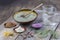 Composition of ceramic bowls of sea clay powder: red, pink, green ,purple ,pitcher of water, dryflowers, eucaliptus
