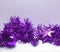 Composition of Christmas purple ornaments on a white surface with a copy of the space