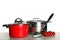 Composition with clean saucepans on table against white background