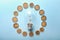 Composition with coins and light bulb on color background. Electricity saving concept