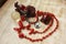 Composition of a crimson horse figurine, red beads made of natural coral, a bracelet with a yin yang symbol, a transparent ball, a