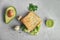 Composition with crisp toast and avocado on table