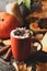 Composition with cup pumpkin latte, cinnamon and pumpkin on wooden background