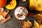 Composition cup of pumpkin latte, cinnamon and pumpkin on wooden background