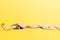 Composition of curled wrapped measuring tape and fork on yellow background. Overweight concept
