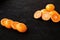 A composition of cut in halves oranges and tangerines on a black background