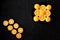 A composition of cut in halves oranges and tangerines on a black background