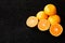 A composition of cut in halves oranges and tangerines on a black background