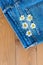 Composition with daisies on a blue background for a card or decor. Seven daisies on a denim