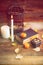 Composition of decorative skull, pumpkin, candles and Halloween decorations on wooden table, on dark color background