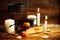 Composition of decorative skull, pumpkin, candles and Halloween decorations on wooden table, on dark color background