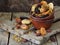 A composition from different varieties of dried fruits on a wooden background - dates, figs, apricots, prunes, raisins, cranberrie