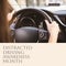 Composition of distracted driving awareness month text over caucasian woman driving car