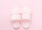 Composition of faux fur slippers on a light pink background