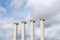 Composition of four ionic column with cloudy sky in the background / copy space / pillar / architecture