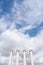 Composition of four ionic column with cloudy sky in the background in vertical view / copy space / pillar /architecture / minimal