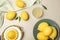 Composition of fresh lemons, juice and squeezer on table