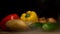 Composition of fresh vegetables, tomato, onion, potatoes and paprika, cucumber, on a black background from the