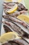 Composition with freshly frozen capelin and lemon close-up on a