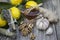 The composition of glass vase with floral honey and wooden spoon with lemon provencal herbs walnuts, garlic and ginger on a woode