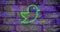 Composition of green neon bird icon on brick wall