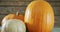 Composition of halloween orange pumpkins against rustic wooden surface