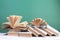 Composition with hardback books, fanned pages on wooden deck table and green background. Books stacking. Back to school. Copy