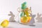 Composition with homemade Easter decor. Glass jar with colorful Easter eggs and wooden rabbits.