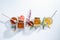 Composition of honey  jars with honey sticks ,flowers and bee pollen on white background