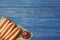 Composition with hot dogs, french fries and sauce on color wooden table, top view