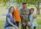 Composition of house drawing over portrait of male soldier with his wife and children