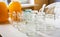 Composition of a large number of jars and three jars of honey standing on a white table against a background of light